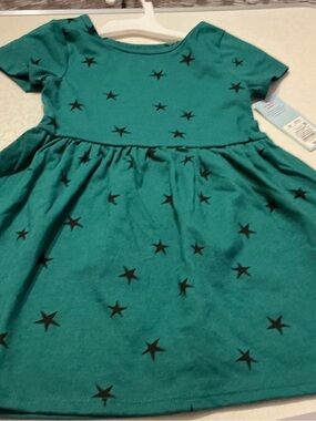 Size 4T dresses paired. A dark green & black starred dress & sage colored